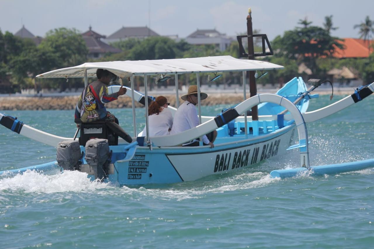 Bali Back In Black branded boat cruising off Kuta