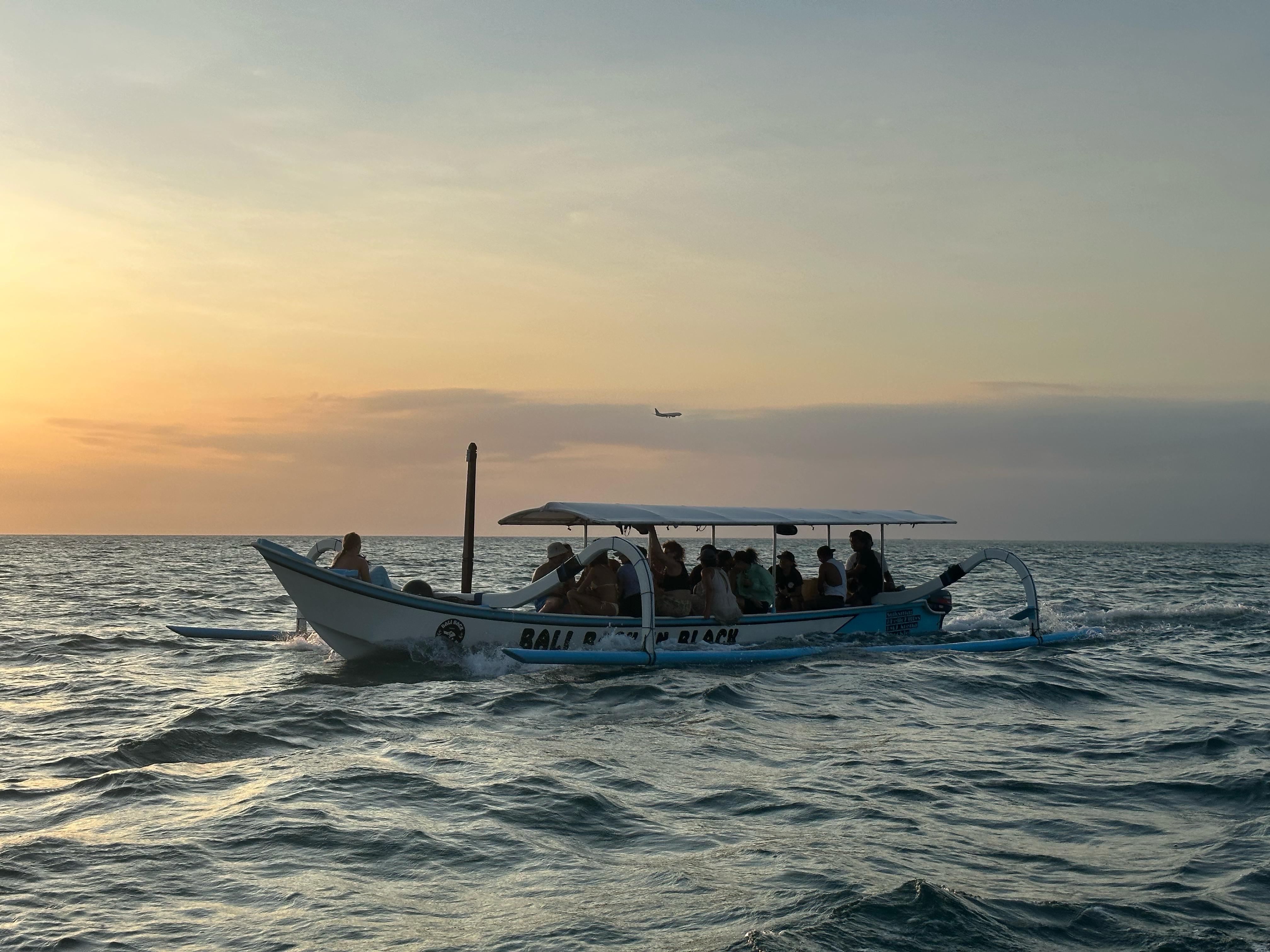 Group of friends enjoying a boat party at dusk