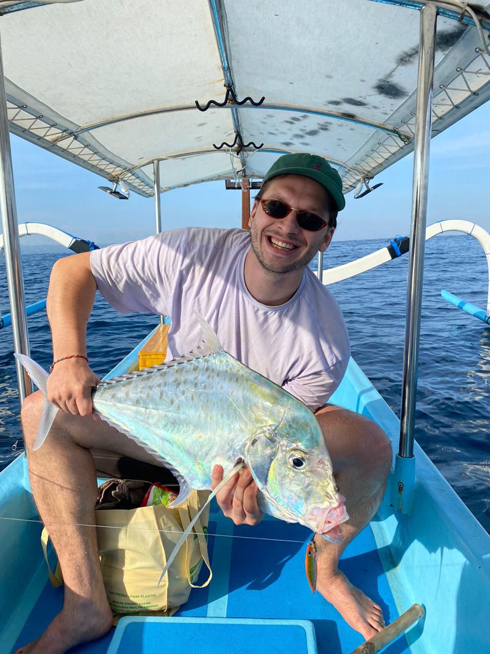 Happy fisherman on a sunny day with his catch