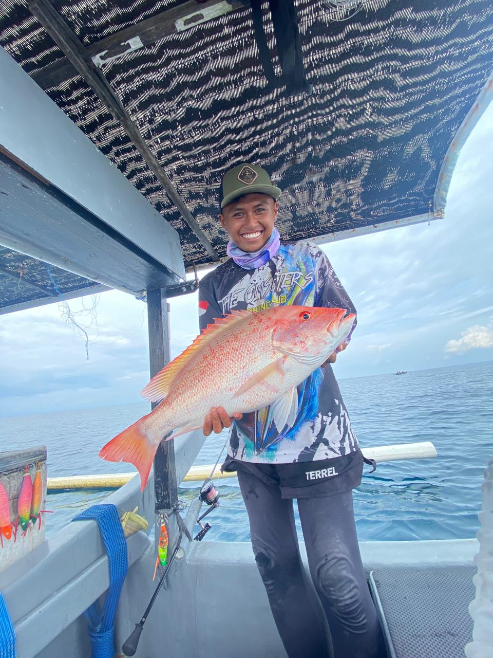 Red snapper catch held up on the boat