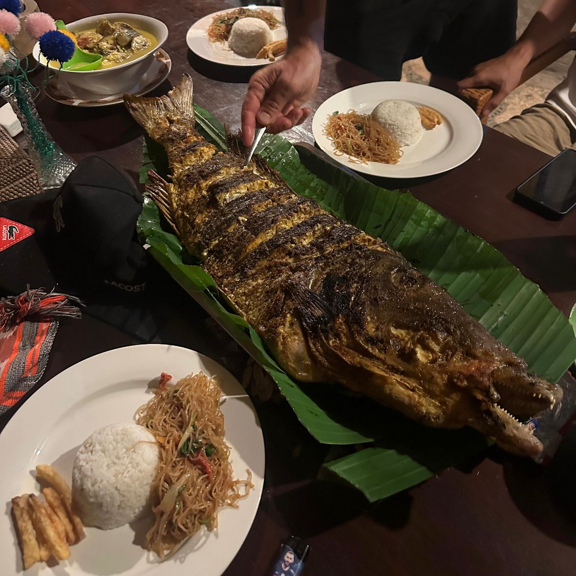 Beautifully plated grilled fish with sides from the beach BBQ