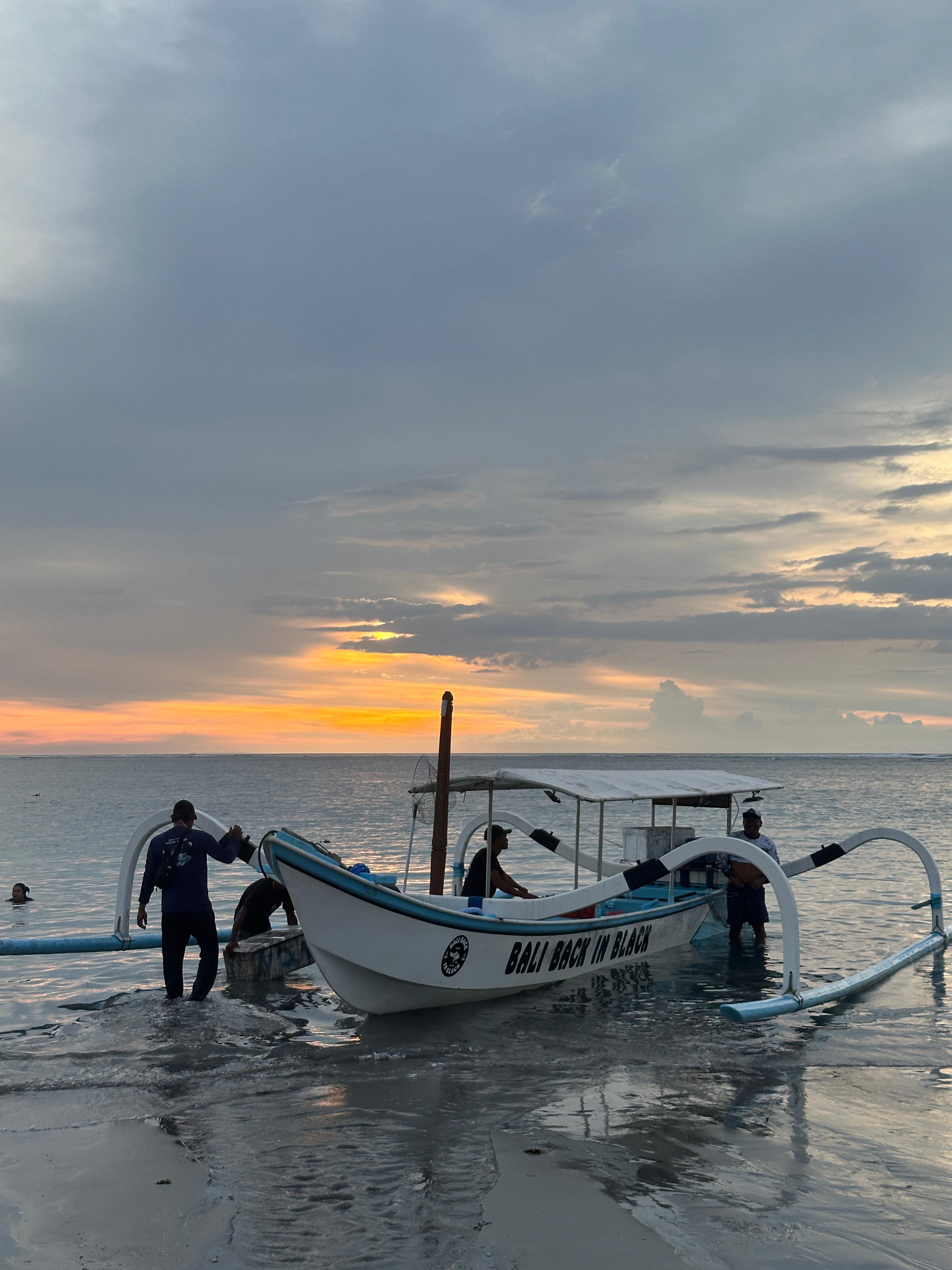 Traditional boat sailing into the Balinese sunset